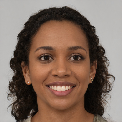 Joyful black young-adult female with medium  brown hair and brown eyes