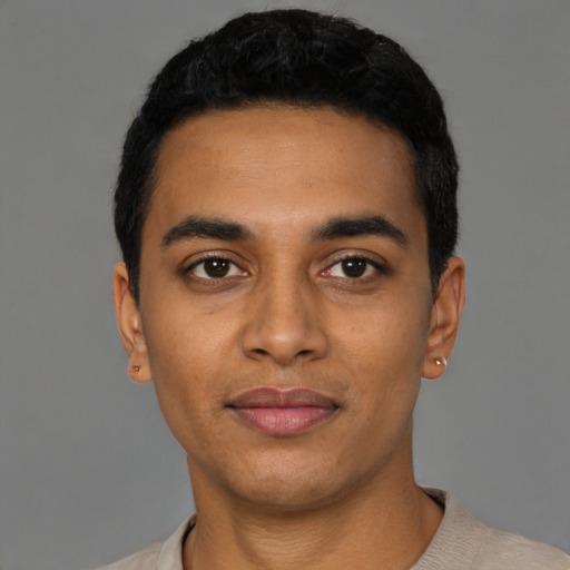 Joyful latino young-adult male with short  black hair and brown eyes