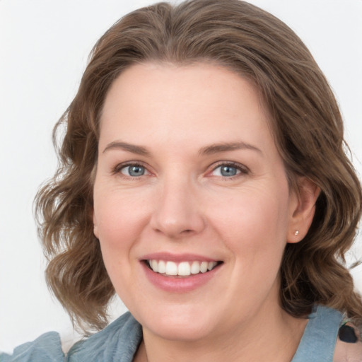 Joyful white young-adult female with medium  brown hair and blue eyes