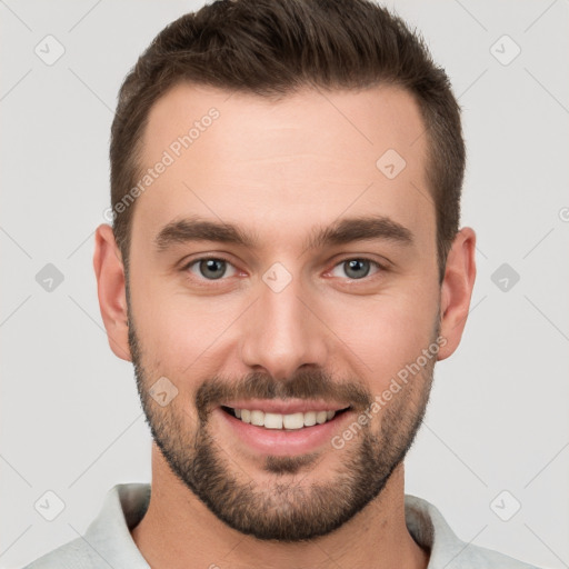 Joyful white young-adult male with short  brown hair and brown eyes