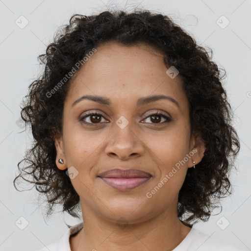 Joyful black young-adult female with medium  brown hair and brown eyes