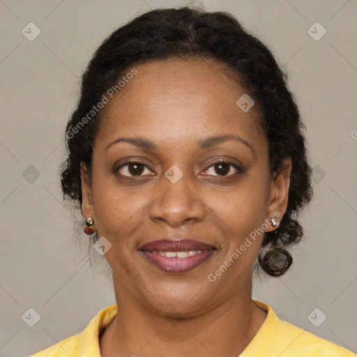 Joyful black adult female with short  brown hair and brown eyes