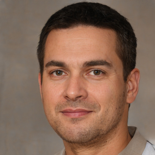 Joyful white adult male with short  brown hair and brown eyes