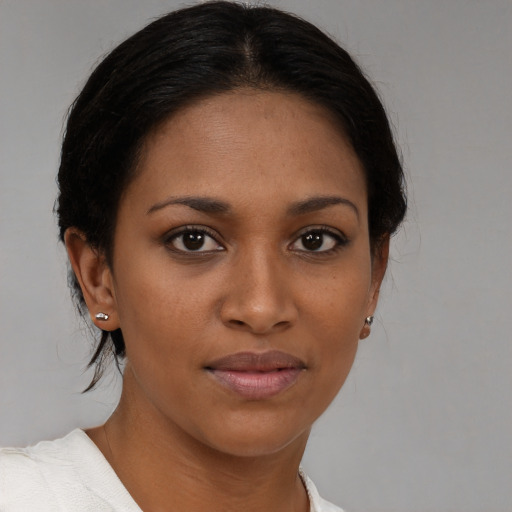 Joyful black young-adult female with medium  brown hair and brown eyes