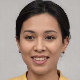 Joyful asian young-adult female with medium  brown hair and brown eyes