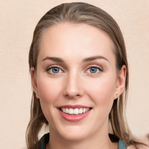 Joyful white young-adult female with medium  brown hair and blue eyes