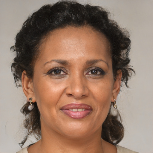 Joyful black adult female with medium  brown hair and brown eyes
