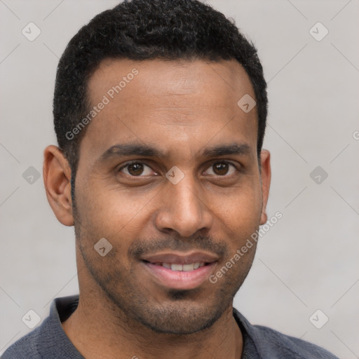 Joyful black young-adult male with short  brown hair and brown eyes