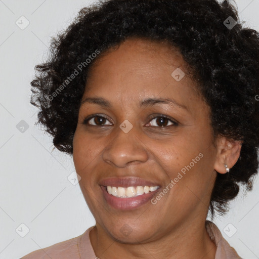 Joyful black adult female with short  brown hair and brown eyes