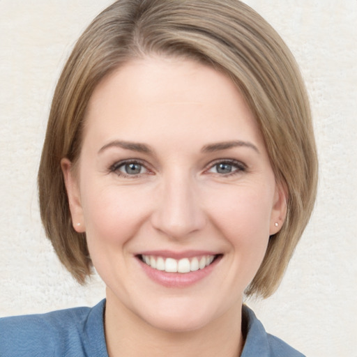 Joyful white young-adult female with medium  brown hair and blue eyes