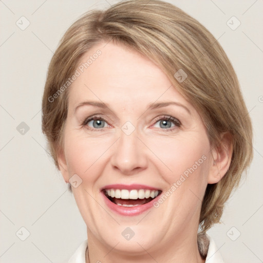 Joyful white adult female with medium  brown hair and green eyes