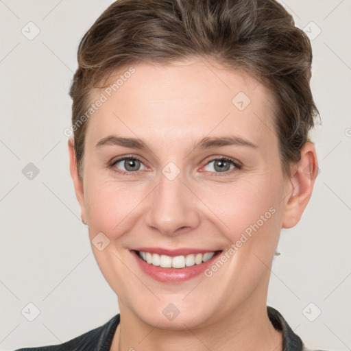 Joyful white young-adult female with short  brown hair and grey eyes