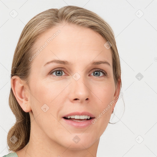 Joyful white young-adult female with long  brown hair and blue eyes