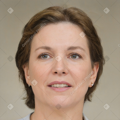 Joyful white adult female with medium  brown hair and green eyes