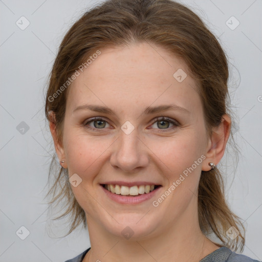 Joyful white young-adult female with medium  brown hair and blue eyes