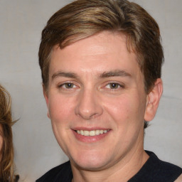 Joyful white young-adult male with medium  brown hair and brown eyes