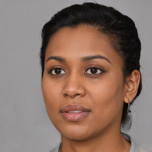 Joyful black young-adult female with medium  black hair and brown eyes