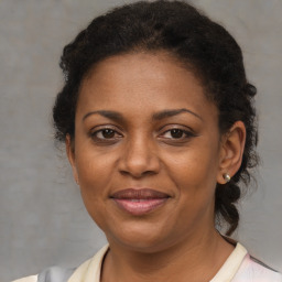 Joyful black adult female with short  brown hair and brown eyes