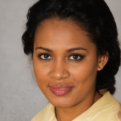 Joyful black young-adult female with short  brown hair and brown eyes