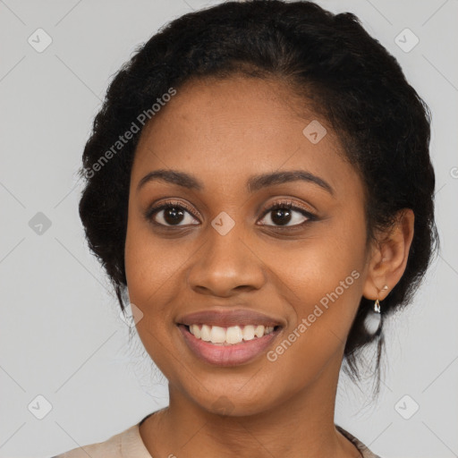 Joyful black young-adult female with long  black hair and brown eyes