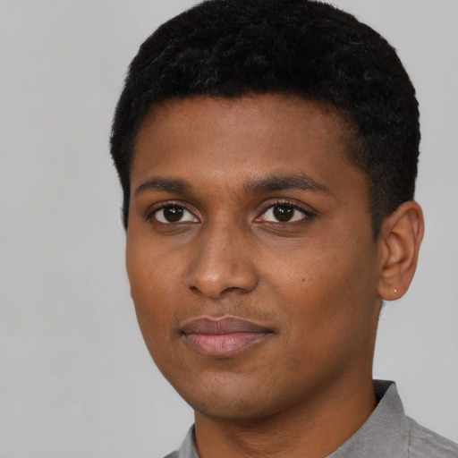 Joyful black young-adult male with short  black hair and brown eyes