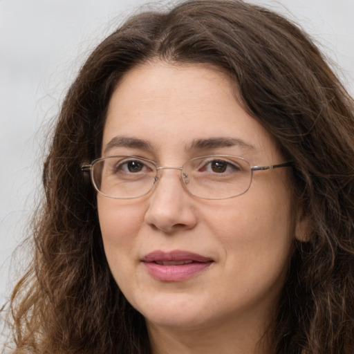 Joyful white adult female with long  brown hair and brown eyes