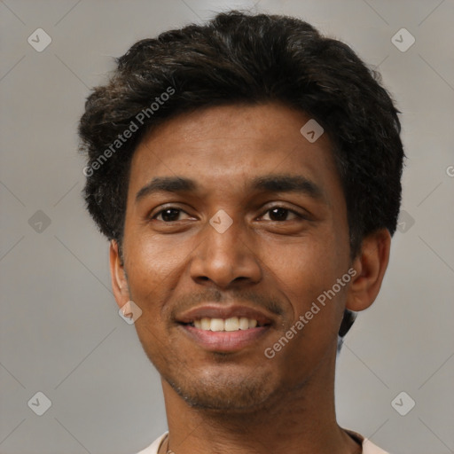 Joyful black young-adult male with short  black hair and brown eyes