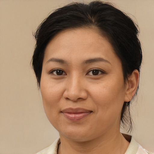 Joyful asian adult female with medium  brown hair and brown eyes