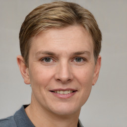 Joyful white adult female with short  brown hair and grey eyes