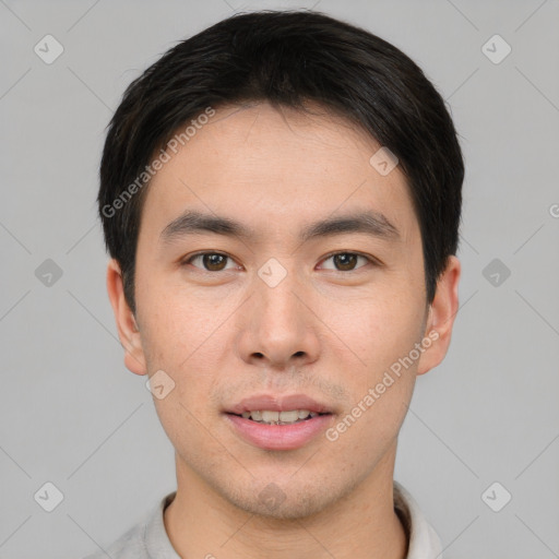 Joyful asian young-adult male with short  brown hair and brown eyes