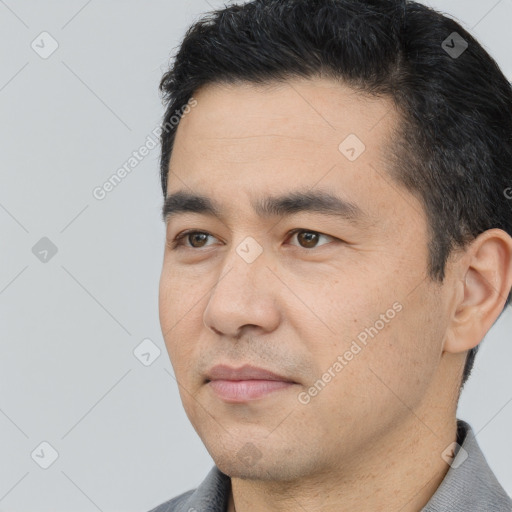 Joyful white young-adult male with short  black hair and brown eyes