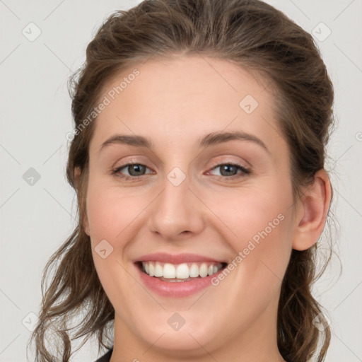 Joyful white young-adult female with long  brown hair and green eyes