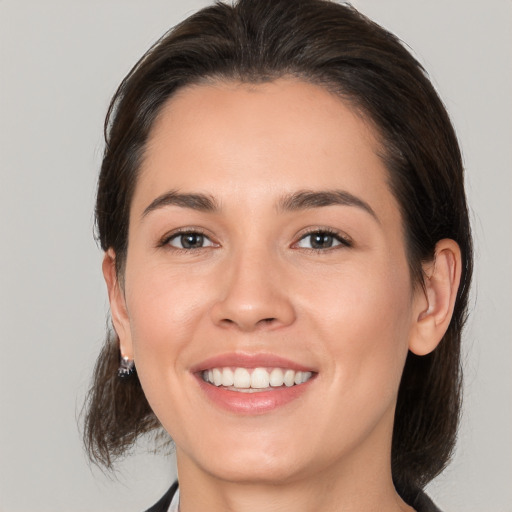 Joyful white young-adult female with medium  brown hair and brown eyes