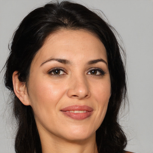 Joyful white adult female with medium  brown hair and brown eyes