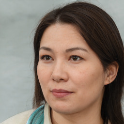 Joyful white adult female with long  brown hair and brown eyes