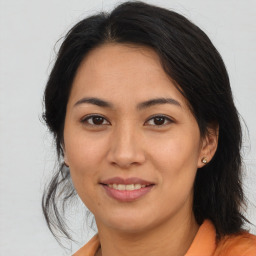 Joyful asian young-adult female with long  brown hair and brown eyes