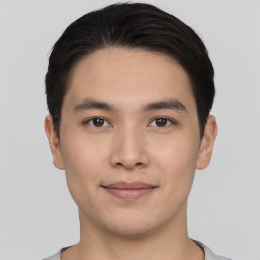 Joyful asian young-adult male with short  black hair and brown eyes