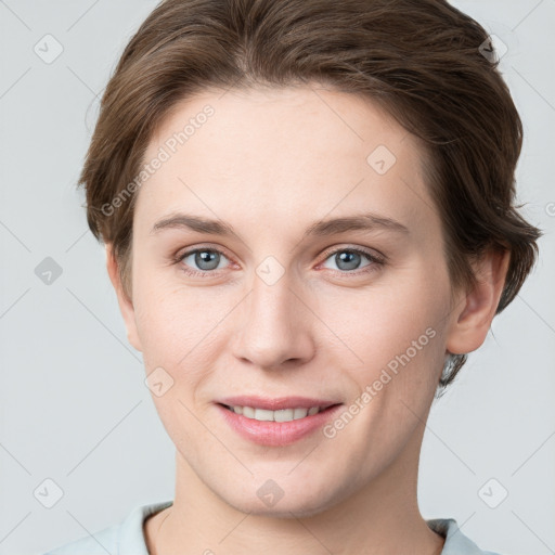 Joyful white young-adult female with short  brown hair and grey eyes