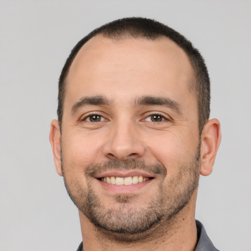 Joyful white adult male with short  brown hair and brown eyes