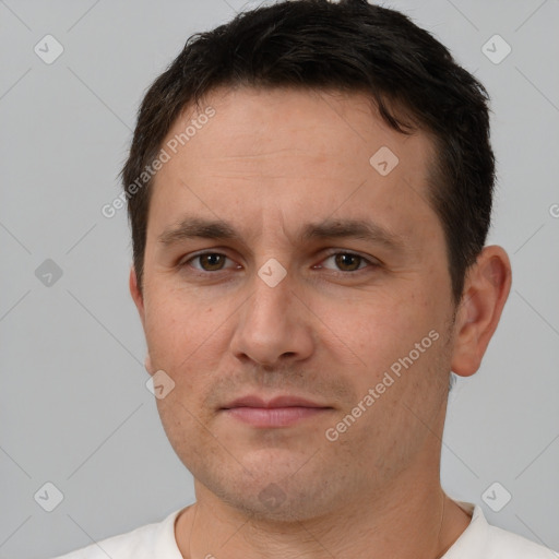 Joyful white adult male with short  brown hair and brown eyes