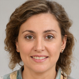 Joyful white young-adult female with medium  brown hair and green eyes