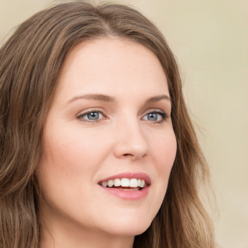 Joyful white young-adult female with long  brown hair and green eyes