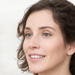 Joyful white young-adult female with medium  brown hair and green eyes