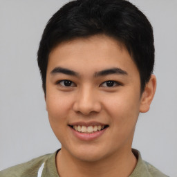 Joyful asian young-adult male with short  brown hair and brown eyes