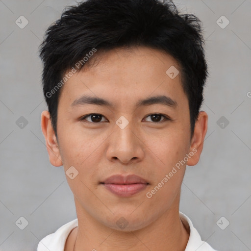 Joyful asian young-adult male with short  black hair and brown eyes