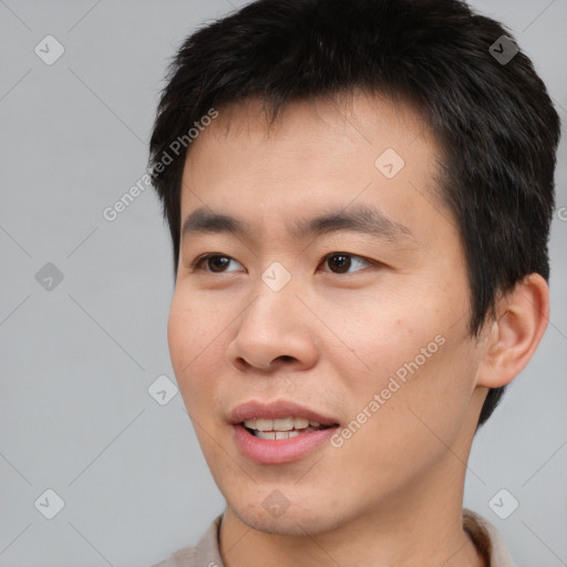 Joyful asian young-adult male with short  brown hair and brown eyes