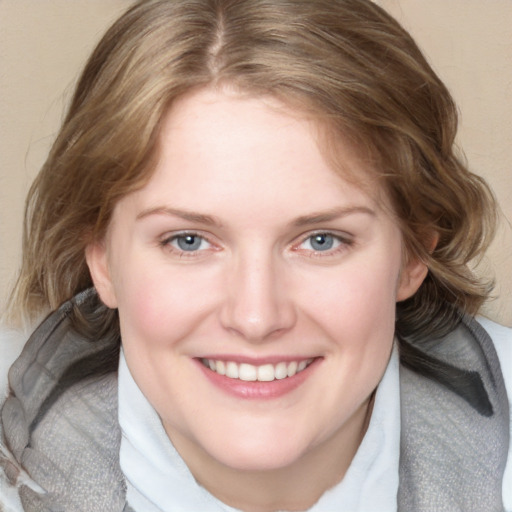 Joyful white young-adult female with medium  brown hair and blue eyes