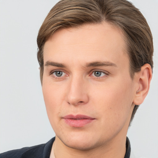 Joyful white young-adult male with short  brown hair and grey eyes