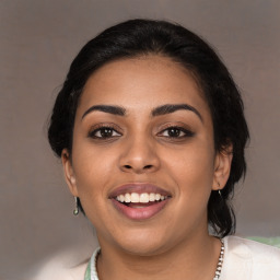 Joyful latino young-adult female with medium  brown hair and brown eyes
