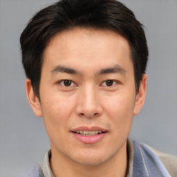 Joyful asian young-adult male with short  brown hair and brown eyes